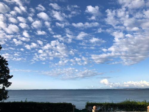 a blue sky with clouds over the ocean at Appartamenti Villa Andrea in Garda