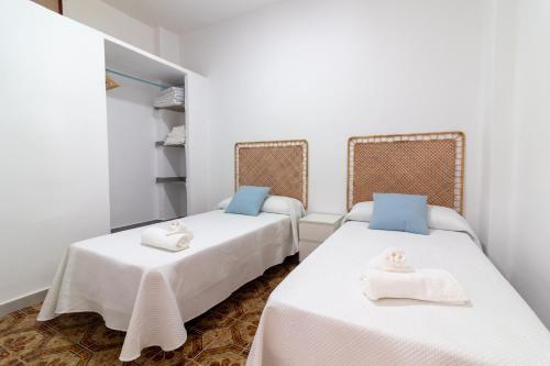 a room with two beds with towels on them at Global Properties, Les Villetes - Magdalena in Moncófar