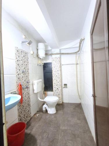 a bathroom with a toilet and a sink at Hotel mountain rangpo in Jāmb