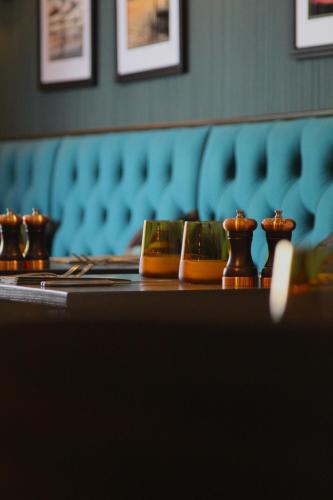 a table with a group of vases on top of it at Coach & Horses Dersingham in Dersingham