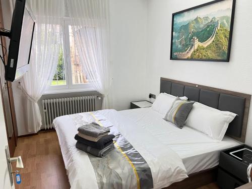 a bedroom with a bed with towels on it at Ferienhaus große Villa "Smart home" in Euskirchen