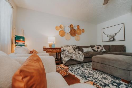 a living room with a couch and a table at Cowboy Den-Hot Tub-Game Room-Pet Friendly-No Pet Fees! in Albuquerque