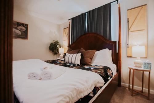 a bedroom with a bed with two towels on it at Cowboy Den-Hot Tub-Game Room-Pet Friendly-No Pet Fees! in Albuquerque