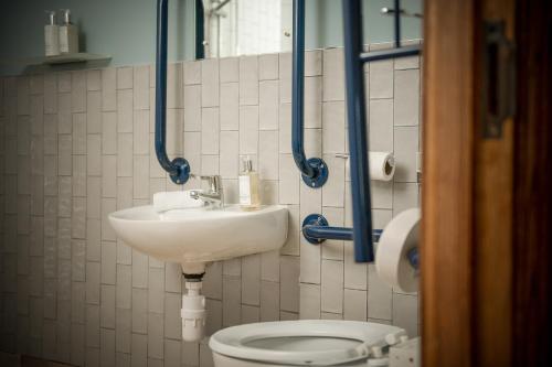 a bathroom with a toilet and a sink at The Royal Heysham in Heysham