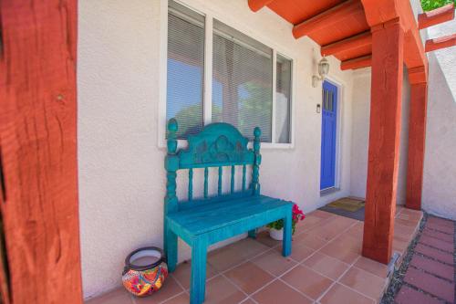 a blue bench sitting on the porch of a house at Cowboy Den-Hot Tub-Game Room-Pet Friendly-No Pet Fees! in Albuquerque