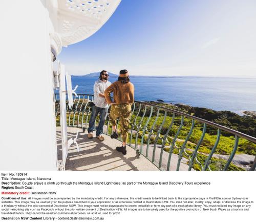 two men standing on a balcony looking at the ocean at Moruya Holiday Park in Moruya