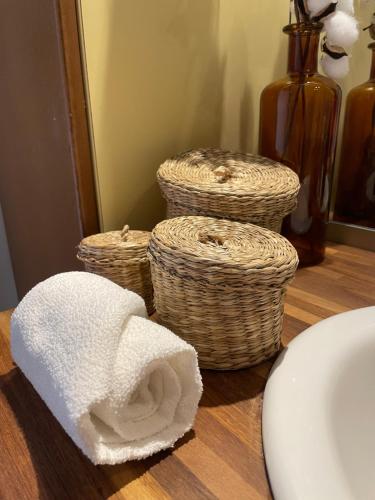 a bathroom with towels and baskets on a counter at Amboise centre ville in Amboise