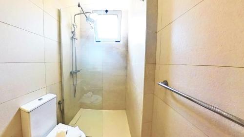 a bathroom with a shower and a toilet in it at Residencial Las Dunas, Best Holiday Home Resort On The Island- VV in Corralejo
