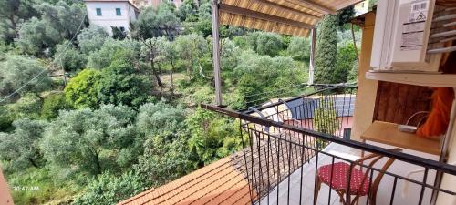 a balcony with two chairs and a view of trees at Le Grazie by The Sea, Beachfront with elevator in Le Grazie