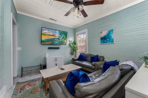 a living room with a couch and a table at Hot Tubs - DT Duplex - Two Blocks off Forsyth Park in Savannah