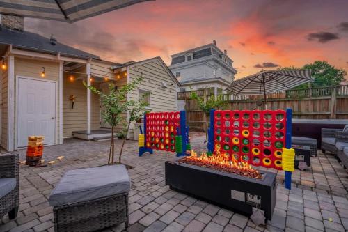 a patio with a fire pit in front of a house at Hot Tubs - DT Duplex - Two Blocks off Forsyth Park in Savannah