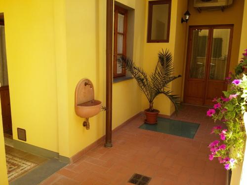 a yellow room with a toilet on the side of a house at Dimora Pieri in Florence