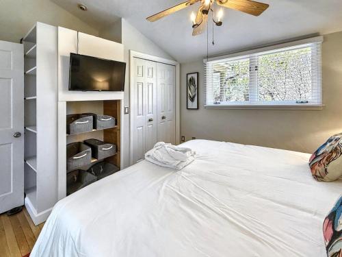 a bedroom with a white bed and a ceiling fan at 826 Wilson Road in Highlands