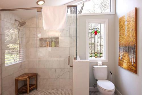 a bathroom with a toilet and a shower with a window at 826 Wilson Road in Highlands