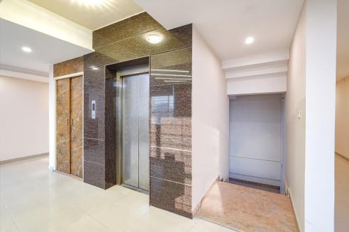 a hallway with a glass shower in a building at FabHotel Indian Suites - Old Madras Rd in Bengaluru