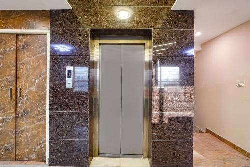 a elevator lobby with a door in a building at FabHotel Indian Suites - Old Madras Rd in Bengaluru