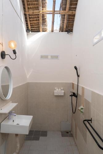 a bathroom with a sink and a shower at Surf Shack Grupuk in Bumbang