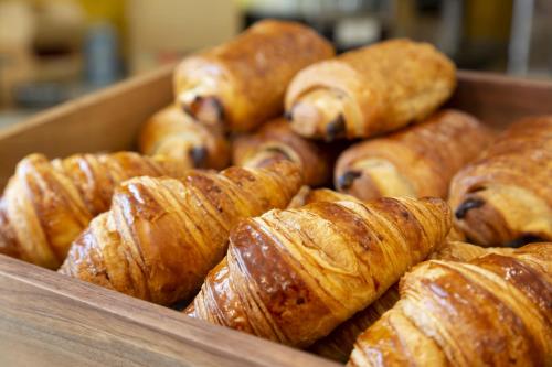 a box of croissants and other pastries at Appart Hotel Odalys City Aix en Provence Le Clos de la Chartreuse in Aix-en-Provence