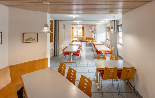 a row of tables and chairs in a restaurant at Jugendherberge Burg Rabeneck Pforzheim in Pforzheim