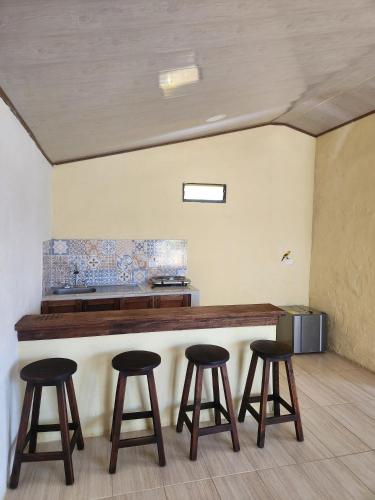 a bar with four stools in a room at Finca QUINTA SAN JUAN in El Reposo