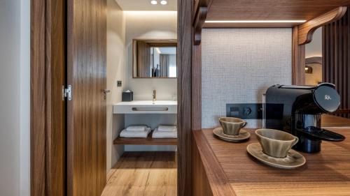 a kitchen with a coffee maker on a counter at Hotel Indigo Gandia Beach by IHG in Gandía