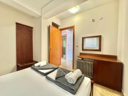 a bedroom with a bed with white towels on it at Contessa Apartments in Budva