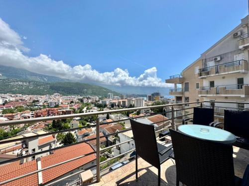 a balcony with a table and chairs and a city at Contessa Apartments in Budva