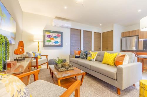 a living room with a couch and a table at Oceanview Stay Pools Walk to Beach & Snorkel in Akumal