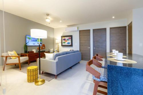 a living room with a couch and a table at Oceanview Stay Pools Walk to Beach & Snorkel in Akumal