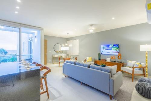 a living room with a blue couch and a table at Oceanview Stay Pools Walk to Beach & Snorkel in Akumal