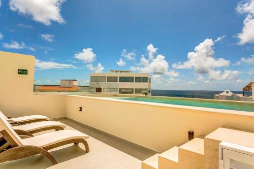 a balcony with chairs and a view of the ocean at Oceanview Stay Pools Walk to Beach & Snorkel in Akumal