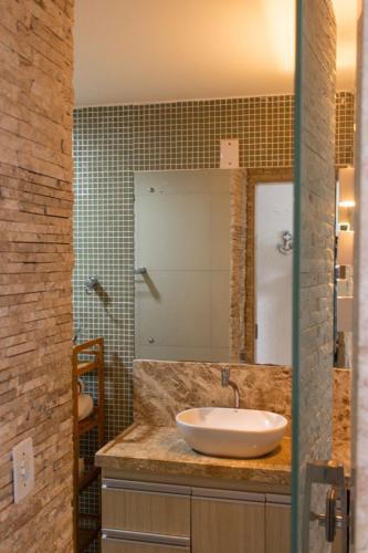 a bathroom with a sink and a mirror at Apartamentos Hotel Marinas in Tamandaré