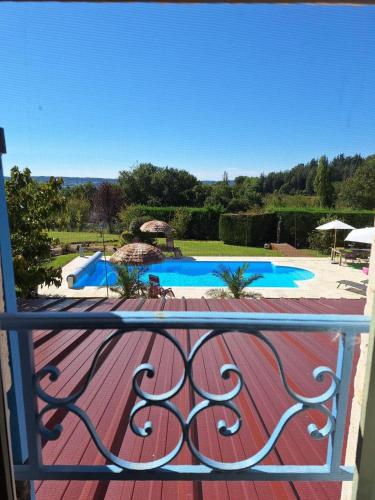 a balcony with a view of a swimming pool at Favau in Villeneuve-sur-Lot