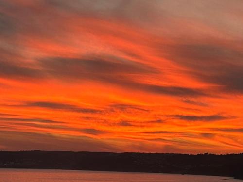 a sunset over a body of water at Ocean View at Kenwyn in Torpoint