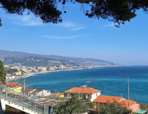 a view of the ocean with a city and a town at VistaBlu Bussana in Arma di Taggia