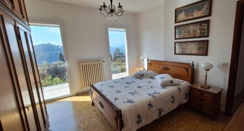 a bedroom with a bed and a large window at VistaBlu Bussana in Arma di Taggia