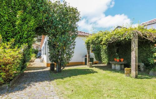 a garden with an orange tree and a bench at GuestReady - Domus Adepta Charming w/ Garden in Furnas
