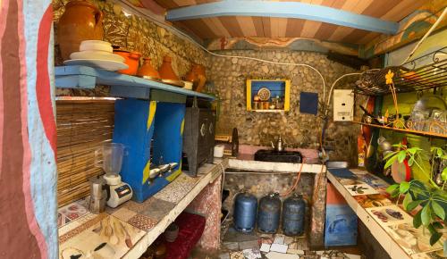 a kitchen with a sink and a counter top at The Mud House in Tamraght Ouzdar
