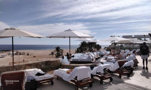 a group of chairs and umbrellas at a beach at Beach&Golf suites in El Bedito