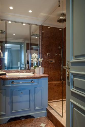 a bathroom with a blue sink and a shower at Althoff Hotel Villa Belrose in Saint-Tropez