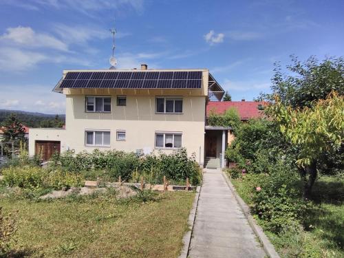 a house with solar panels on the roof at APARTMA HLUBOKA in Hluboká nad Vltavou