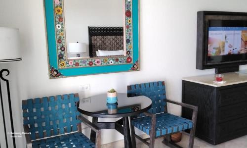 a dining room with a table and two chairs and a mirror at Beach&Golf suites in El Bedito