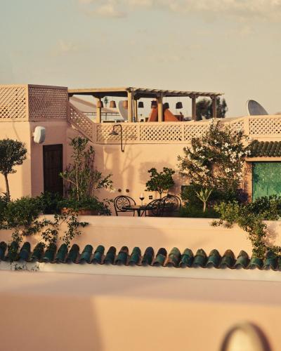 a balcony of a house with people sitting on it at IZZA Marrakech in Marrakech