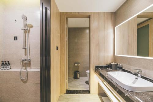 a bathroom with a sink and a shower at Atour Hotel Shanghai Anting in Shanghai