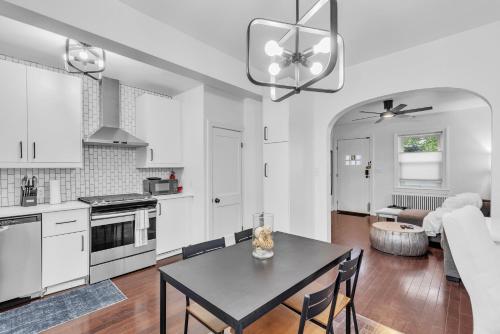 a kitchen and living room with a table and chairs at Two-Bedroom House in Baltimore