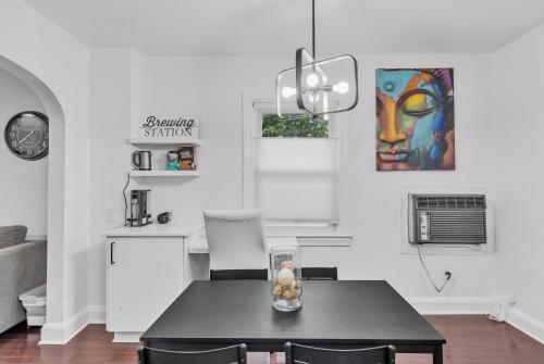 a dining room with a table and a painting on the wall at Two-Bedroom House in Baltimore