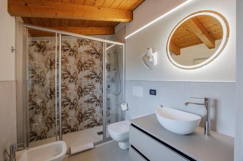 a bathroom with a shower and a sink and a mirror at B&B Ca' Marognole in Caprino Veronese