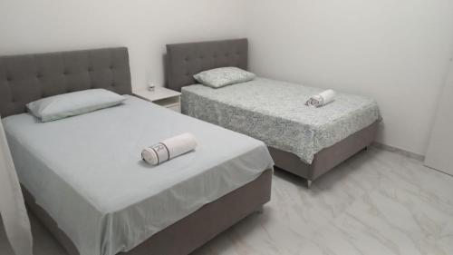 two beds in a small room with two beds sidx sidx sidx at Luxury Home in Volta Mantovana