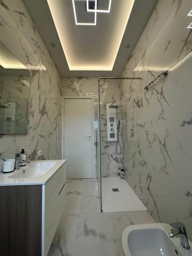 a bathroom with a shower and a sink and a toilet at Luxury Home in Volta Mantovana