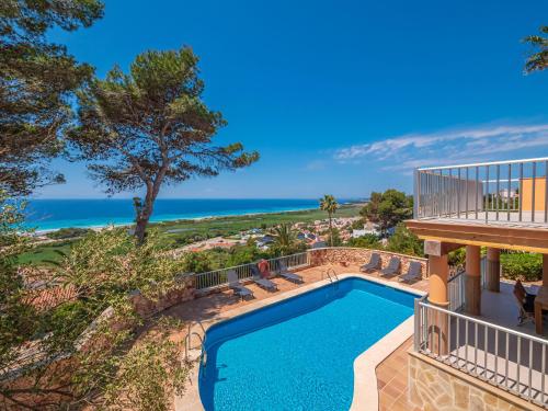 an image of a swimming pool with a balcony and the ocean at Villa Armonia in Son Bou